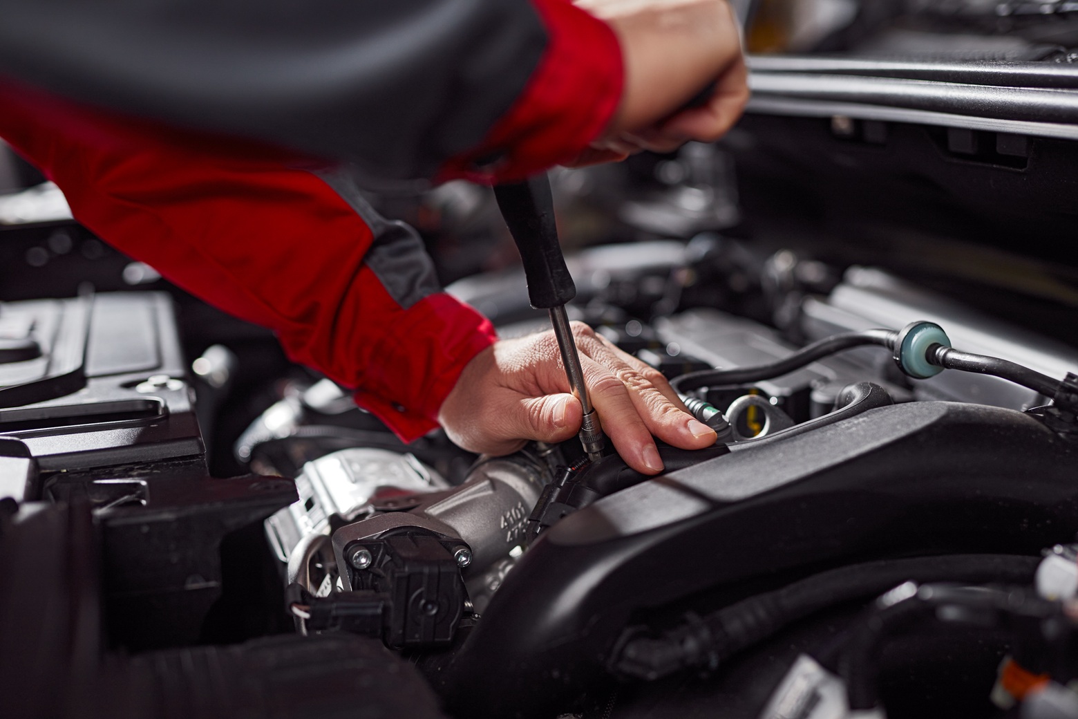mechanic repairing car engine in auto repair shop