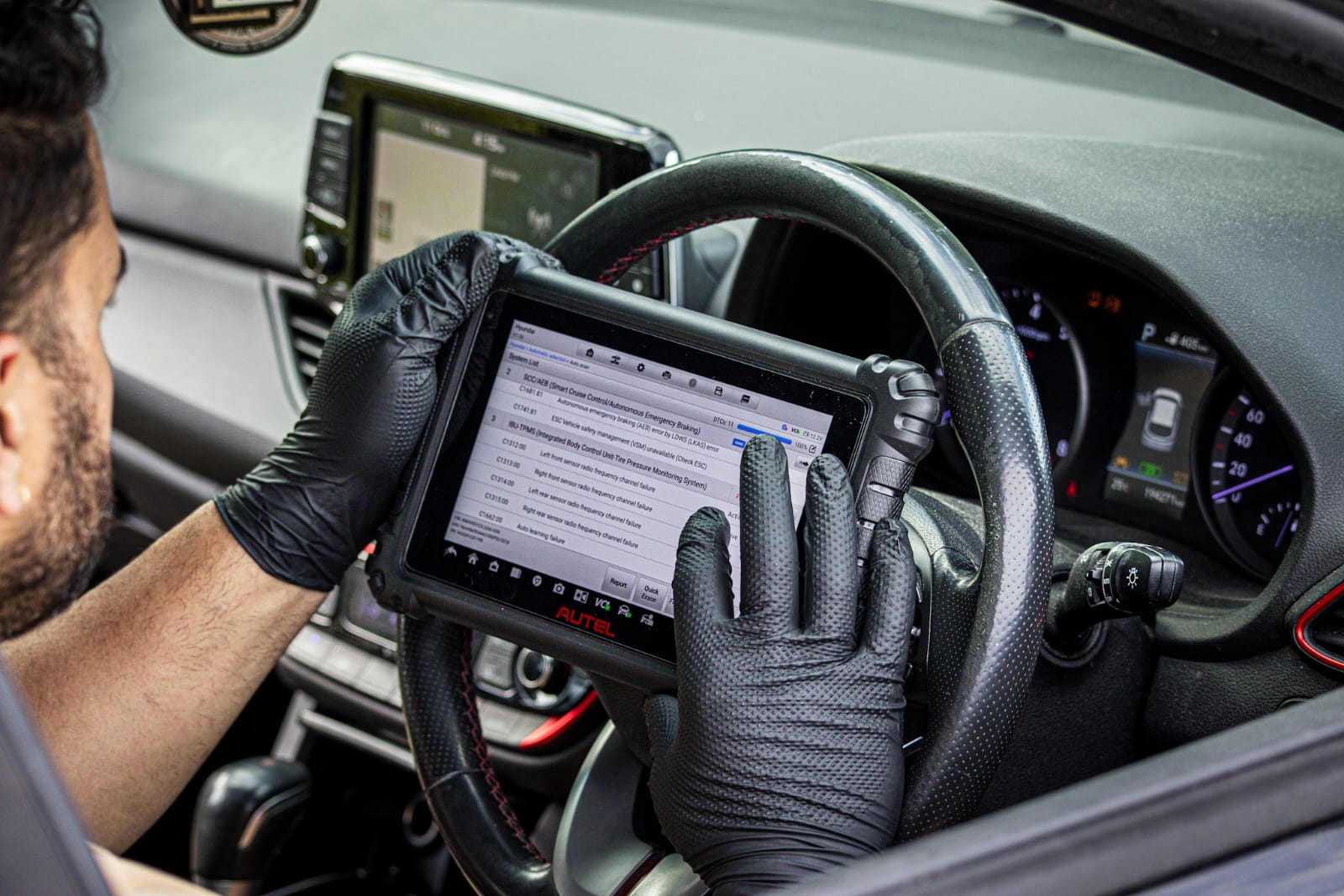Cole checking a vehicle with a diagnostic scan tool
