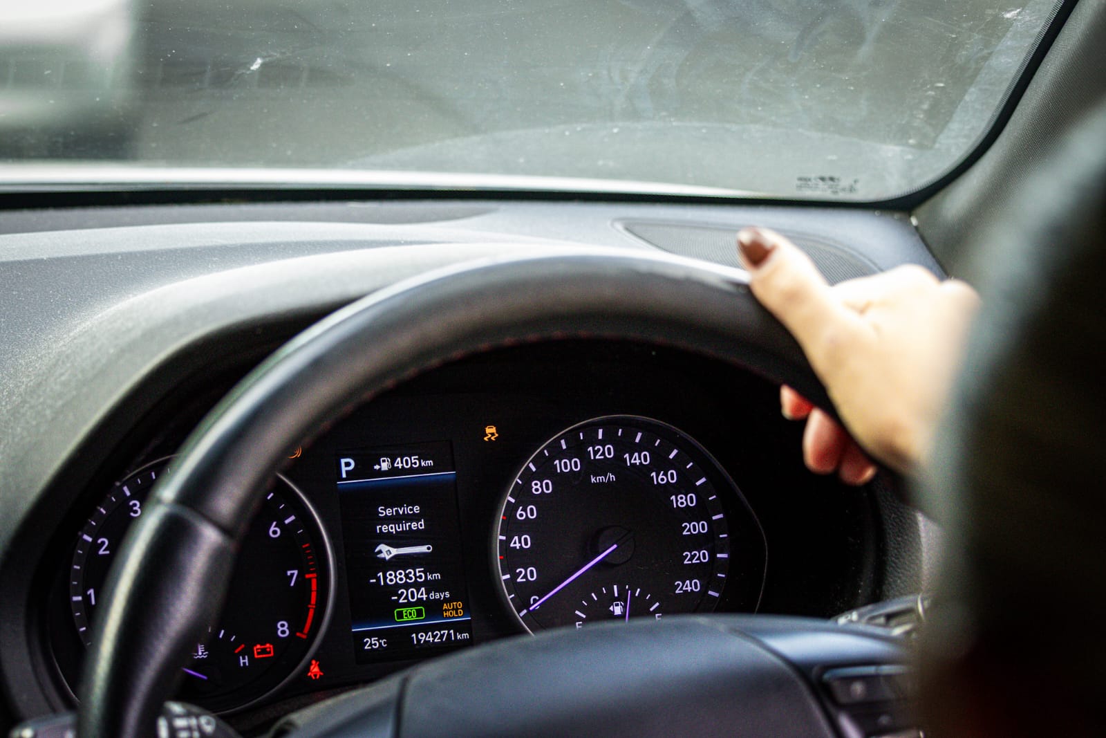 A vehicle dashboard displaying a service reminder